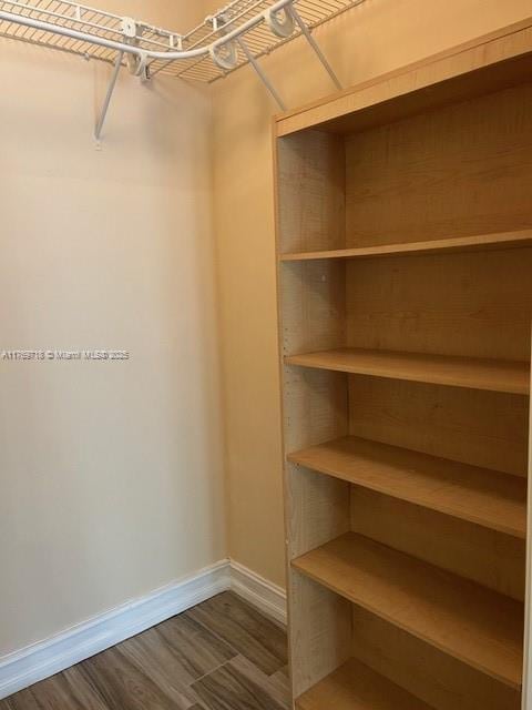 3001 NE 185th St Unit 418, Aventura, FL 33180 - walk in closet with dark wood-style floors