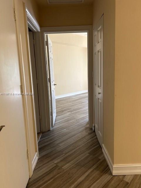 3001 NE 185th St Unit 418, Aventura, FL 33180 - hallway with wood finished floors, baseboards, and attic access