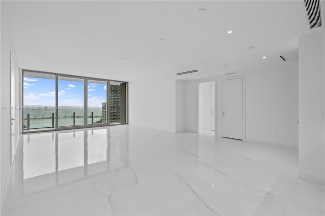 300 Biscayne Blvd Way Unit 1103, Miami, FL 33131 - spare room featuring expansive windows, a water view, light marble finish floors, and recessed lighting