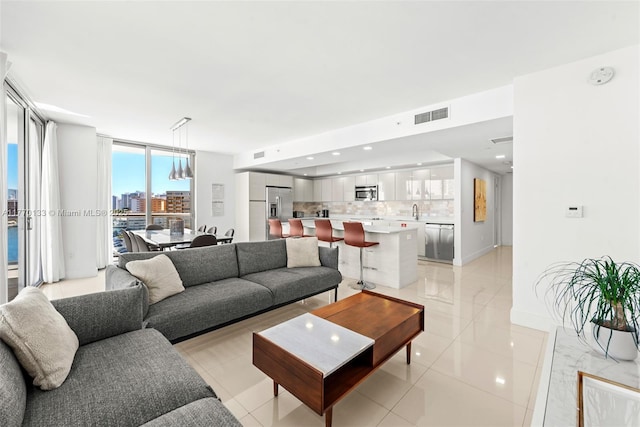 2600 E Hallandale Beach Blvd Unit T1001, Hallandale Beach, FL 33009 - living area with light tile patterned floors, baseboards, and recessed lighting