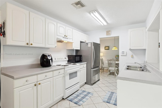4499 NW 18th Ave, Oakland Park, FL 33309 - kitchen featuring white range with electric cooktop, black microwave, under cabinet range hood, a sink, and freestanding refrigerator