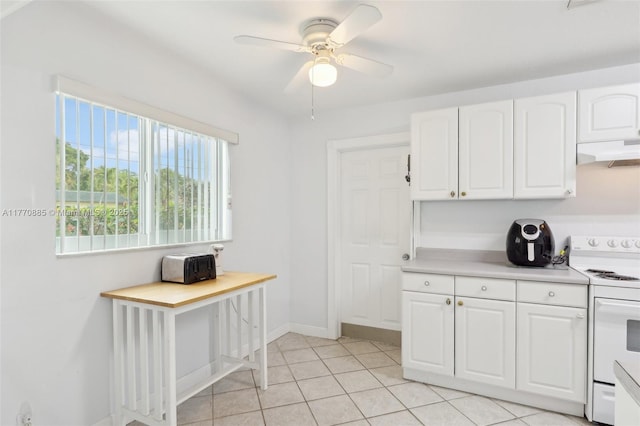 4499 NW 18th Ave, Oakland Park, FL 33309 - kitchen featuring white electric range, white cabinetry, under cabinet range hood, light countertops, and ceiling fan