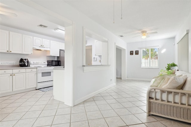 4499 NW 18th Ave, Oakland Park, FL 33309 - kitchen featuring white range with electric cooktop, under cabinet range hood, black microwave, a ceiling fan, and light countertops