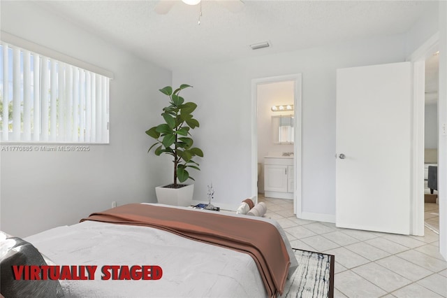 4499 NW 18th Ave, Oakland Park, FL 33309 - bedroom with light tile patterned flooring, ensuite bath, a ceiling fan, and a textured ceiling