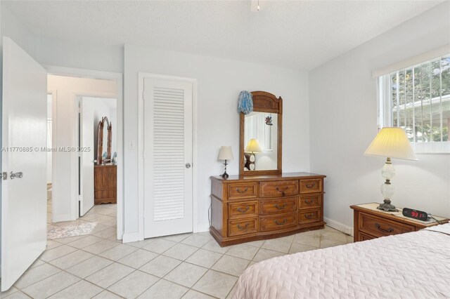 4499 NW 18th Ave, Oakland Park, FL 33309 - bedroom featuring light tile patterned flooring, a closet, and baseboards