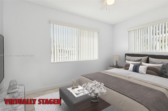 4499 NW 18th Ave, Oakland Park, FL 33309 - tiled bedroom with multiple windows, baseboards, and a ceiling fan