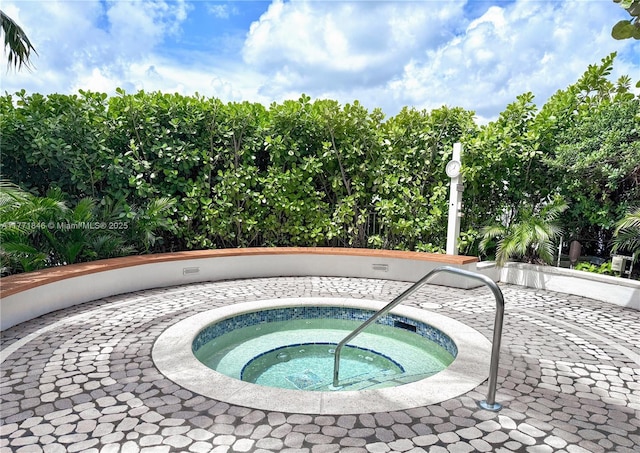 view of swimming pool featuring a community hot tub