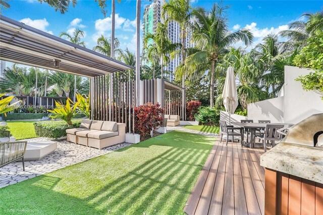 view of yard featuring an outdoor hangout area, fence, a patio, and outdoor dining space