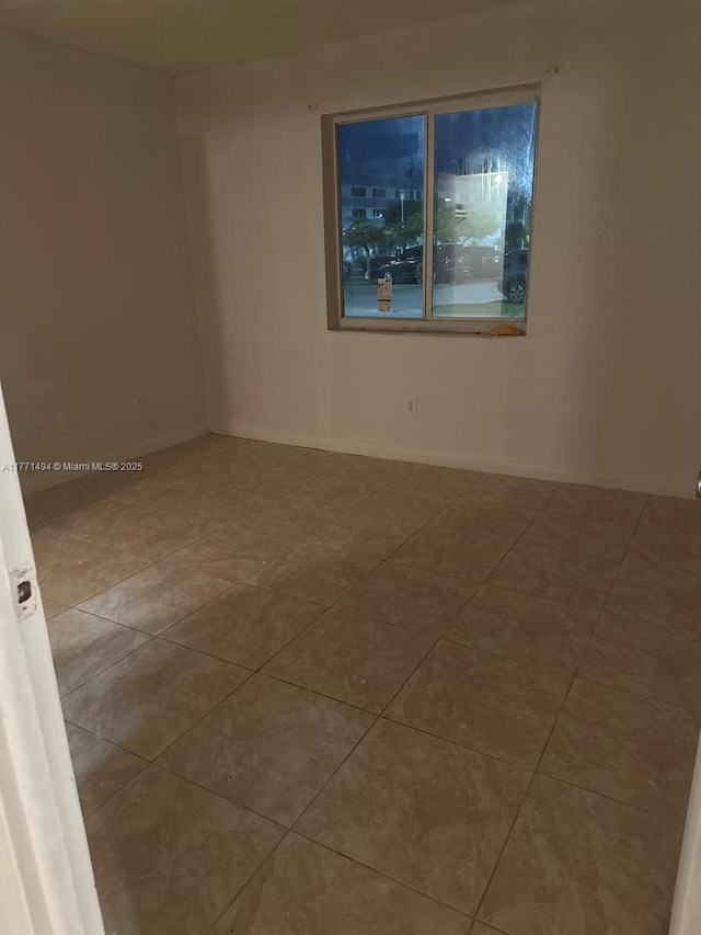tiled empty room with baseboards