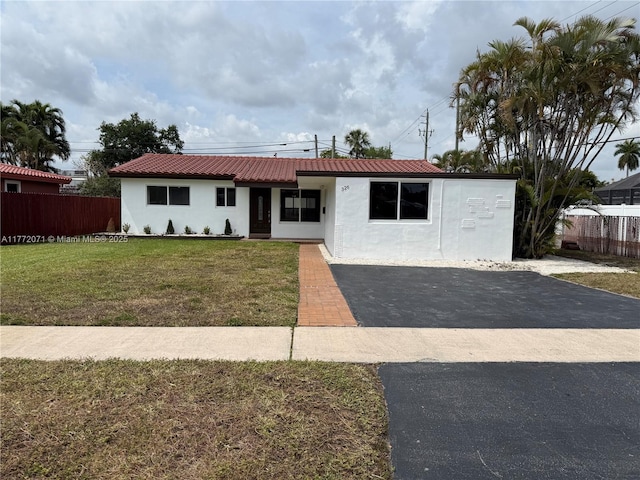 326 N 32nd Ave, Hollywood, FL 33021 - single story home with stucco siding, asphalt driveway, and metal roof