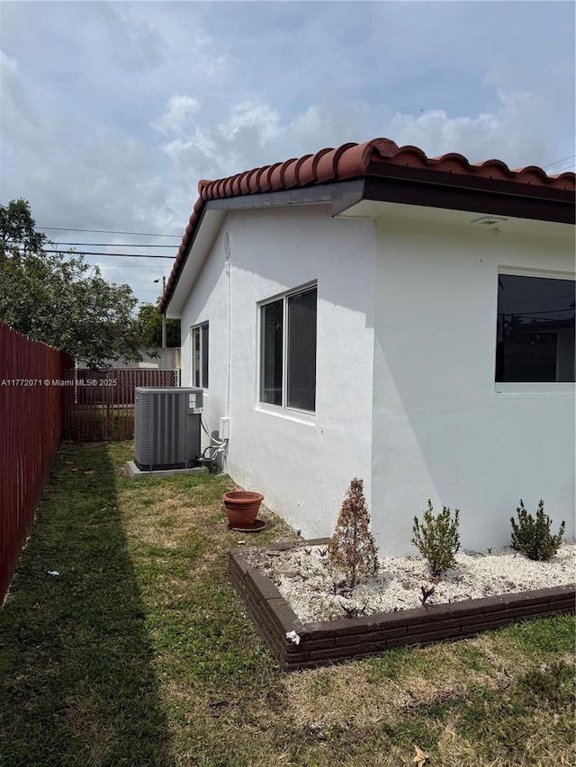 326 N 32nd Ave, Hollywood, FL 33021 - view of home's exterior with central AC, stucco siding, and a tile roof