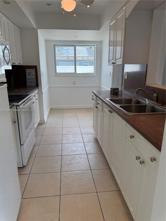 326 N 32nd Ave, Hollywood, FL 33021 - kitchen featuring a sink, electric range oven, dark countertops, and light tile patterned floors