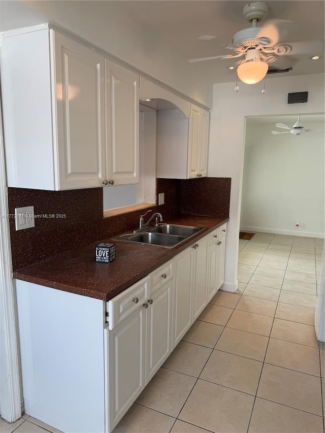 326 N 32nd Ave, Hollywood, FL 33021 - kitchen with a sink, light tile patterned flooring, dark countertops, and white cabinets