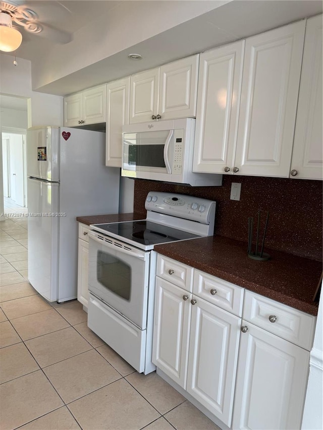 326 N 32nd Ave, Hollywood, FL 33021 - kitchen featuring white appliances, light tile patterned floors, white cabinets, and tasteful backsplash