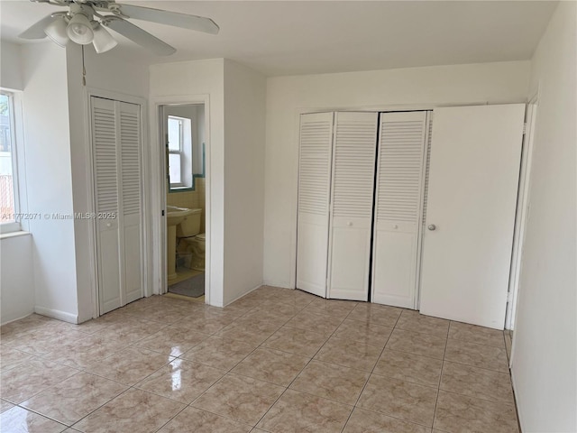 326 N 32nd Ave, Hollywood, FL 33021 - unfurnished bedroom featuring light tile patterned floors, ensuite bath, and ceiling fan