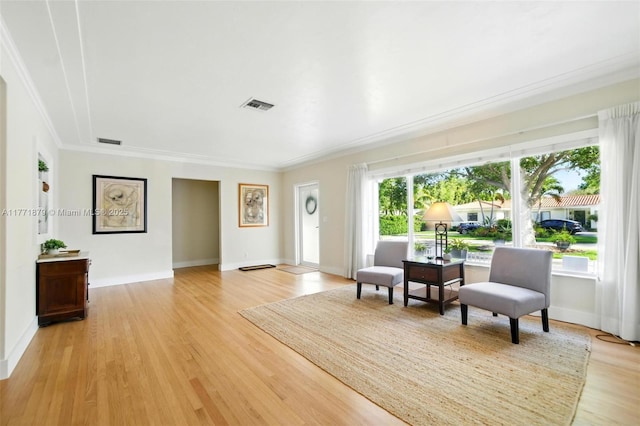 1259 NE 98th St, Miami Shores, FL 33138 - living area featuring visible vents, ornamental molding, and light wood-style flooring