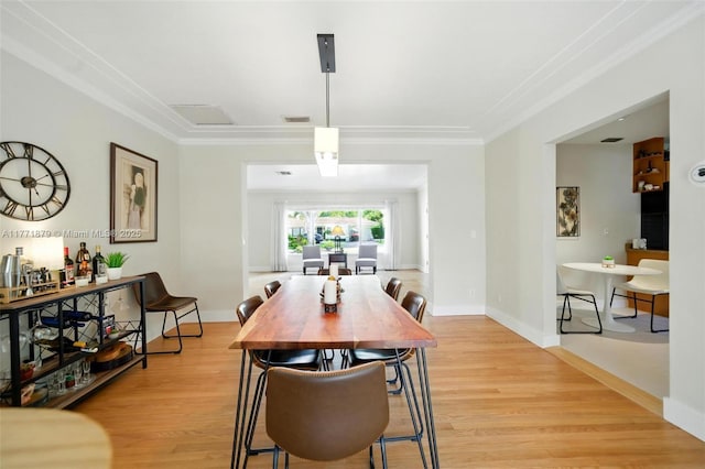 1259 NE 98th St, Miami Shores, FL 33138 - dining area with light wood finished floors, visible vents, baseboards, and ornamental molding