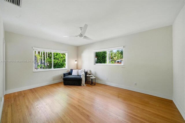 1259 NE 98th St, Miami Shores, FL 33138 - living area featuring wood finished floors, ceiling fan, baseboards, and visible vents