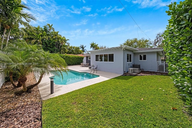 1259 NE 98th St, Miami Shores, FL 33138 - back of house with a fenced in pool, stucco siding, a patio area, fence, and a lawn