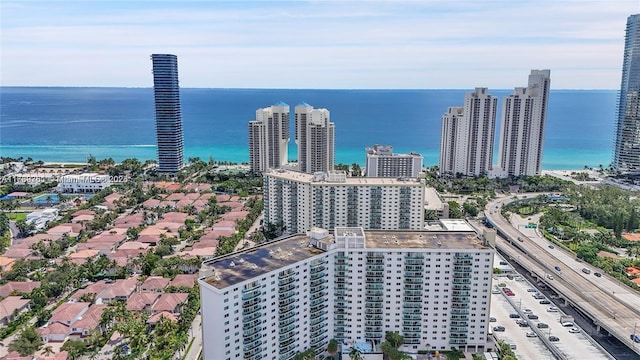drone / aerial view featuring a water view and a view of city