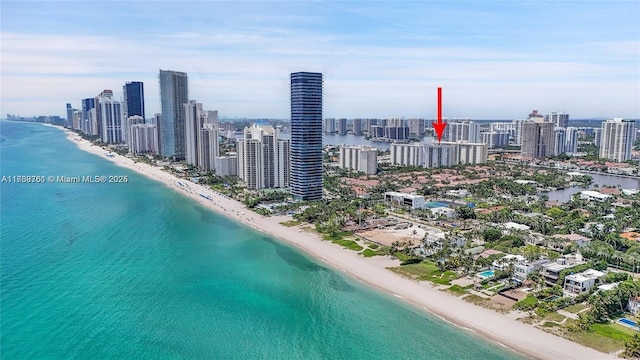 aerial view featuring a water view, a city view, and a view of the beach