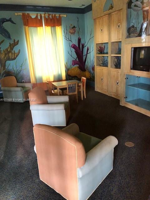 4271 San Marino Blvd Unit 206, West Palm Beach, FL 33409 - living room featuring dark colored carpet