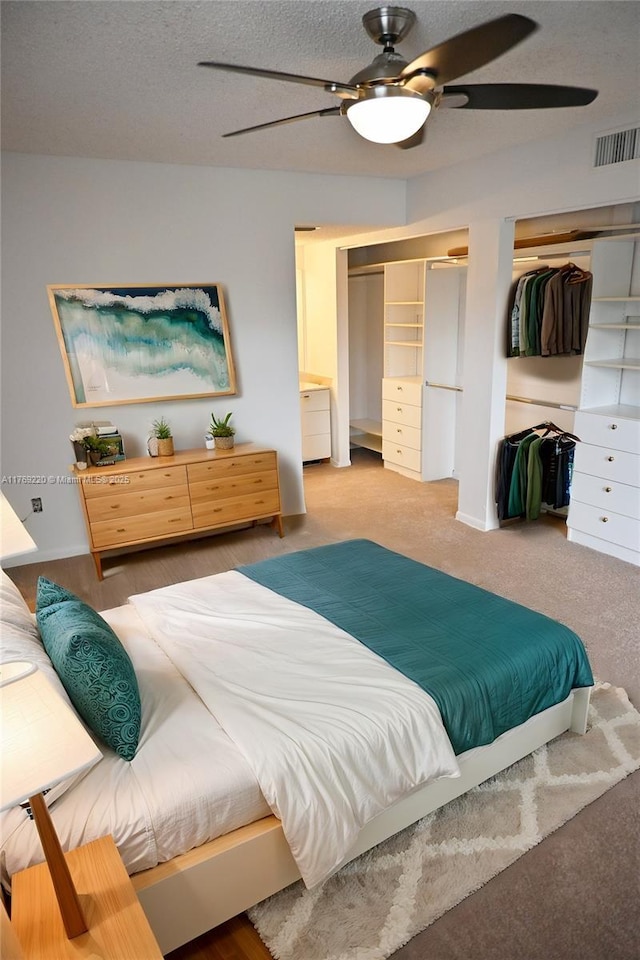 1170 N Hiatus Rd Unit 1170, Pembroke Pines, FL 33026 - carpeted bedroom with two closets, ceiling fan, and a textured ceiling