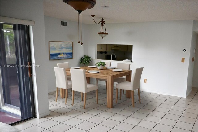 1170 N Hiatus Rd Unit 1170, Pembroke Pines, FL 33026 - dining space with baseboards and light tile patterned flooring