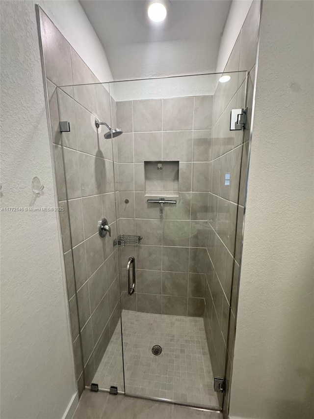bathroom with a shower stall