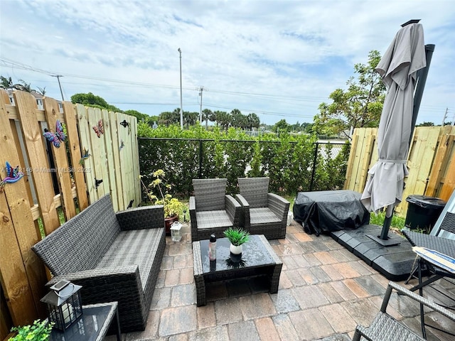 view of patio / terrace with outdoor lounge area, a grill, and fence