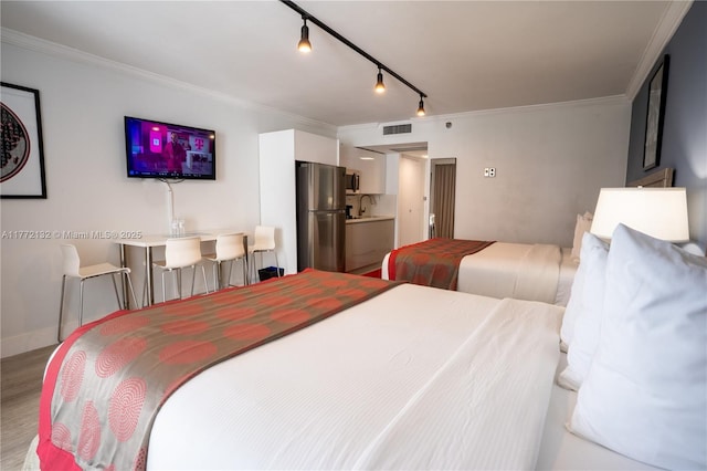 19201 Collins Ave Unit 425, Sunny Isles Beach, FL 33160 - bedroom featuring visible vents, crown molding, wood finished floors, a sink, and freestanding refrigerator