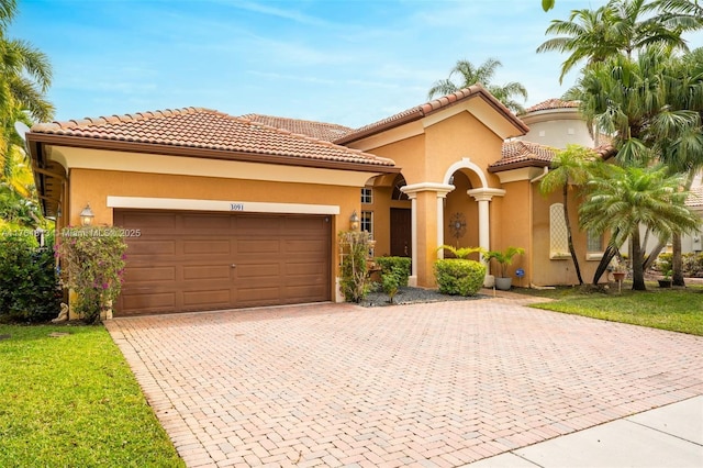 3091 SW 195th Ter, Miramar, FL 33029 - mediterranean / spanish home with a garage, decorative driveway, stucco siding, and a tiled roof