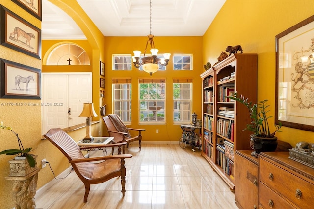 3091 SW 195th Ter, Miramar, FL 33029 - living area featuring a notable chandelier, arched walkways, baseboards, a tray ceiling, and ornamental molding