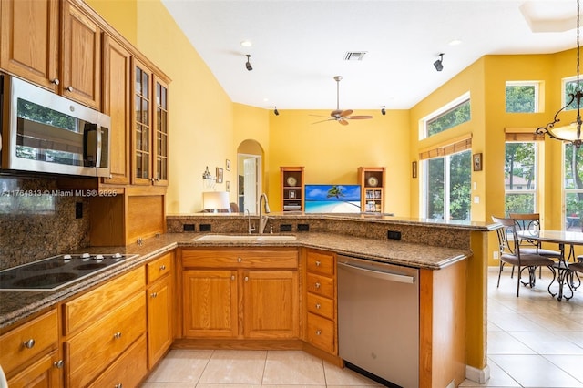 3091 SW 195th Ter, Miramar, FL 33029 - kitchen featuring brown cabinetry, visible vents, appliances with stainless steel finishes, a sink, and a peninsula