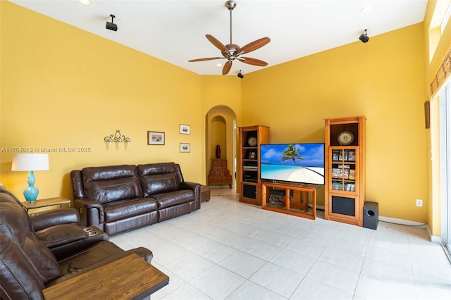 3091 SW 195th Ter, Miramar, FL 33029 - living room featuring baseboards, arched walkways, a ceiling fan, and light tile patterned flooring