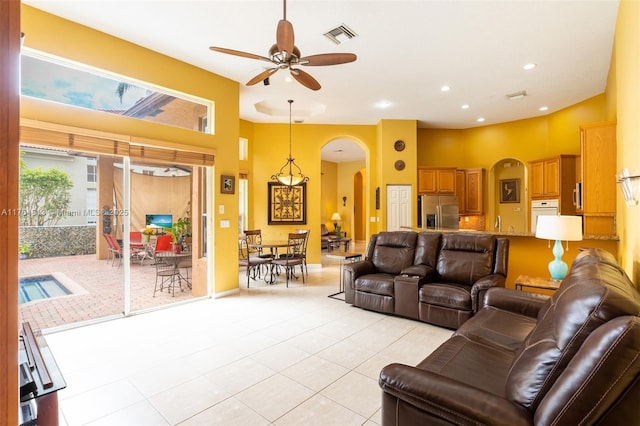 3091 SW 195th Ter, Miramar, FL 33029 - living room with arched walkways, a ceiling fan, a healthy amount of sunlight, and light tile patterned flooring