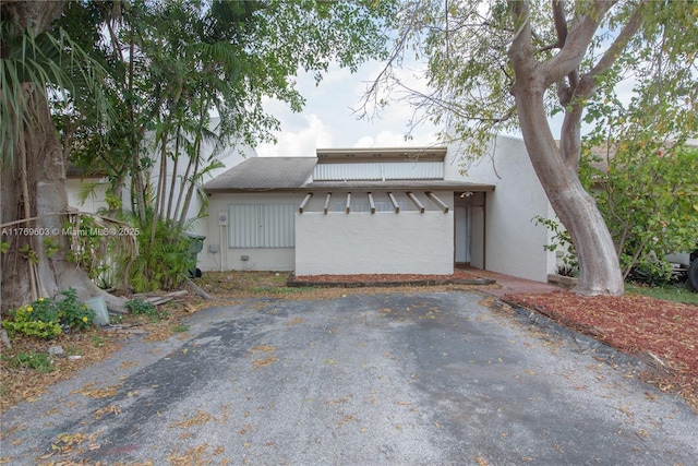 view of side of home with stucco siding