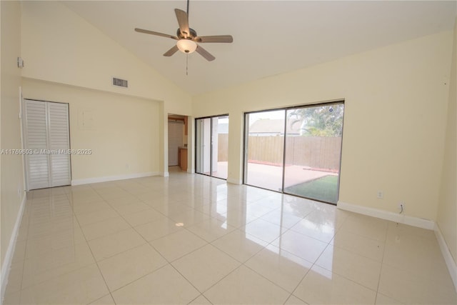 unfurnished room featuring a ceiling fan, light tile patterned flooring, high vaulted ceiling, and baseboards