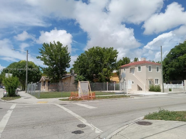 view of road with sidewalks, street lighting, and curbs