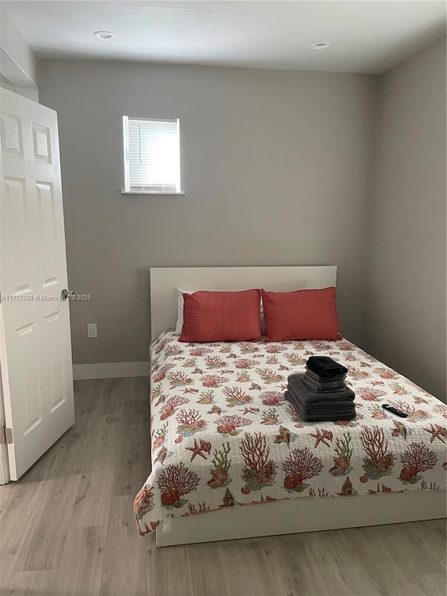 bedroom with baseboards and light wood-style floors
