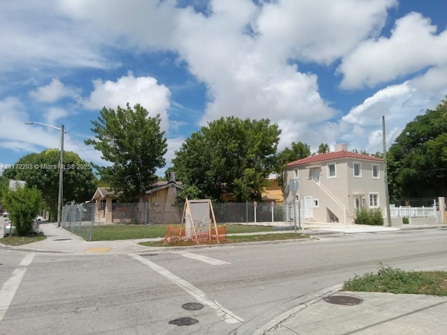 view of street with sidewalks, street lighting, and curbs