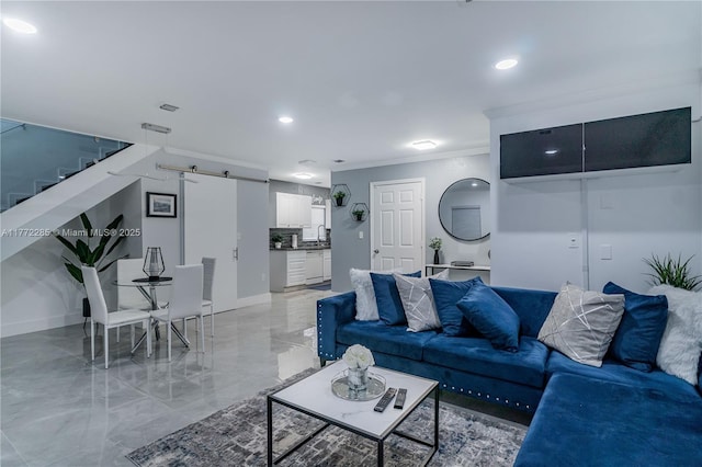 living area featuring marble finish floor, baseboards, crown molding, and stairway
