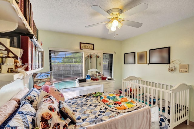 bedroom with a textured ceiling and ceiling fan