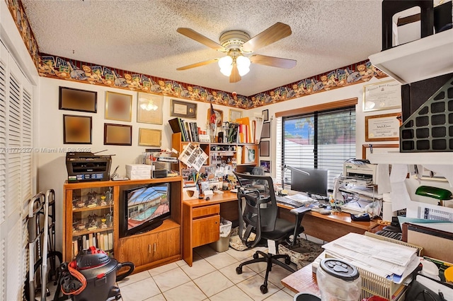 office space featuring a ceiling fan, a textured ceiling, and light tile patterned flooring