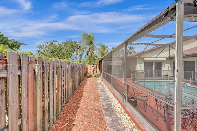 exterior space with a lanai, a fenced backyard, and a fenced in pool