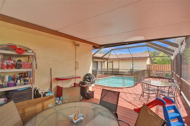 view of swimming pool with a fenced in pool, a lanai, fence, a patio area, and outdoor dining space