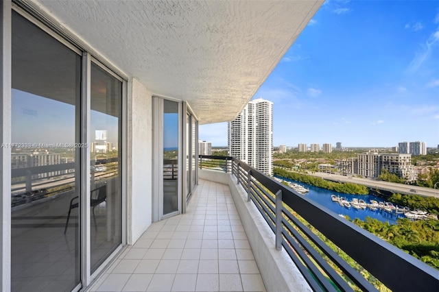 balcony with a water view and a city view