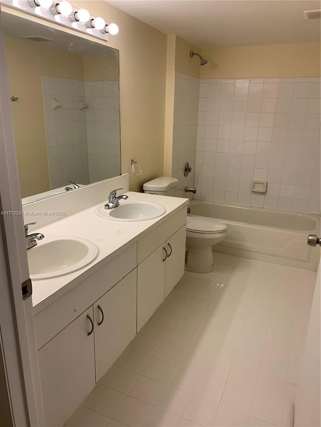 bathroom with  shower combination, tile patterned flooring, double vanity, and toilet