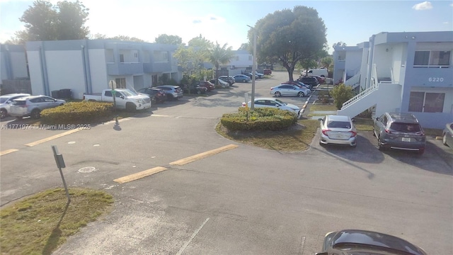 uncovered parking lot with a residential view