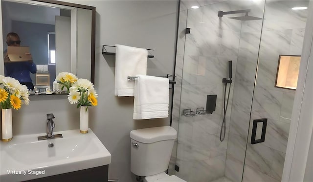 bathroom with a marble finish shower, toilet, and vanity